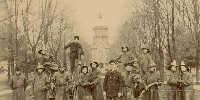 Notre Dame Fire Department firemen posed on Main Quad in front of Main Building, c1899.