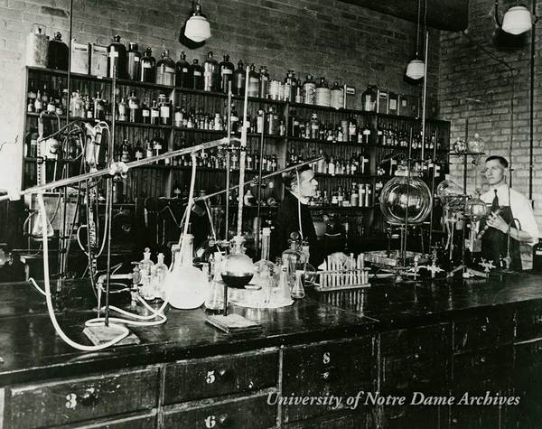 Rev. Julius Nieuwland in a chemistry laboratory with a student, 1933-1934.